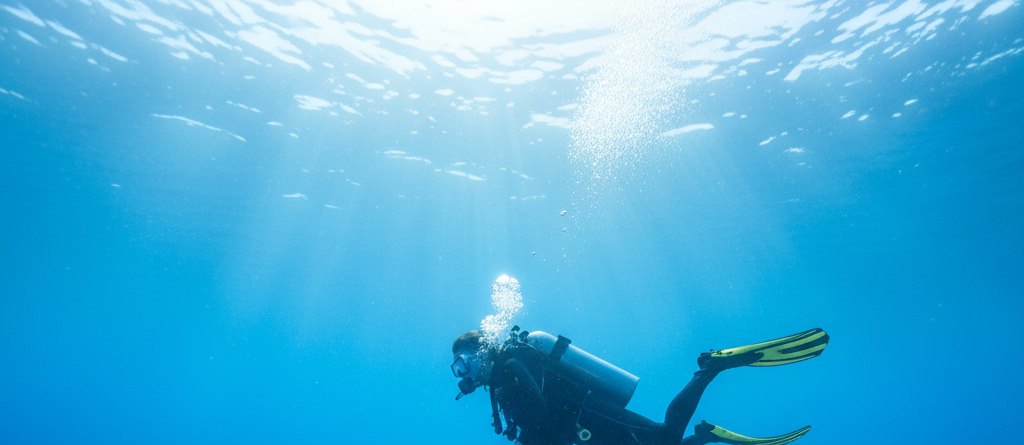Scuba diving in Bali with colorful coral and tropical fish